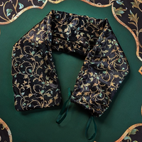 The satin bag for The Witch's Mat, black with a gold and green vine pattern