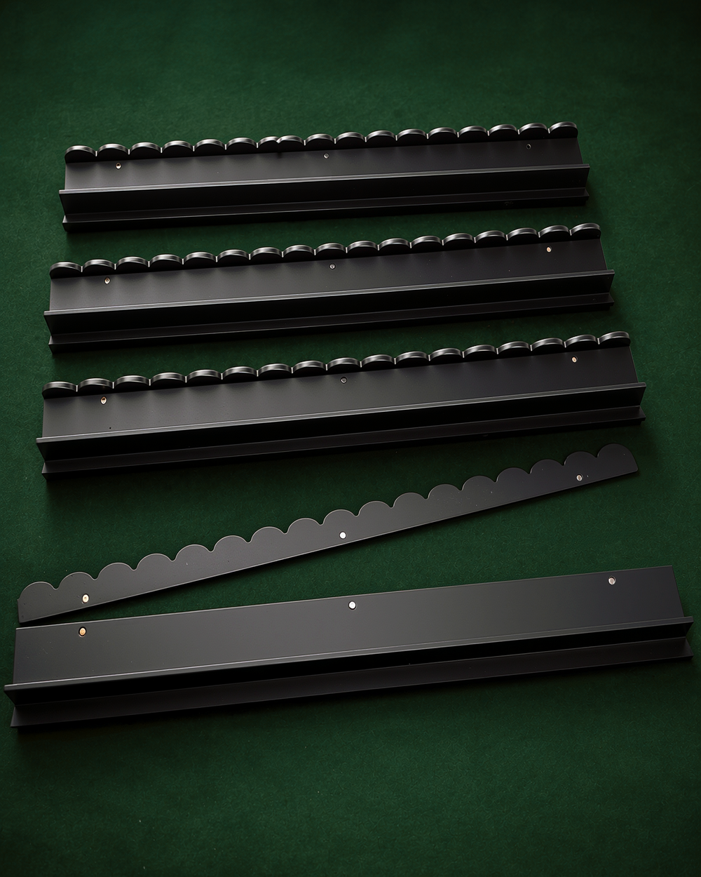 The Witch's Racks: four black solid wood mahjong racks with scalloped edges and a tile pusher