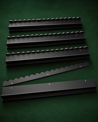 The Witch's Racks: four black solid wood mahjong racks with scalloped edges and a tile pusher