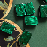 Green swirled acrylic mahjong tiles resting on The Witch's Mat